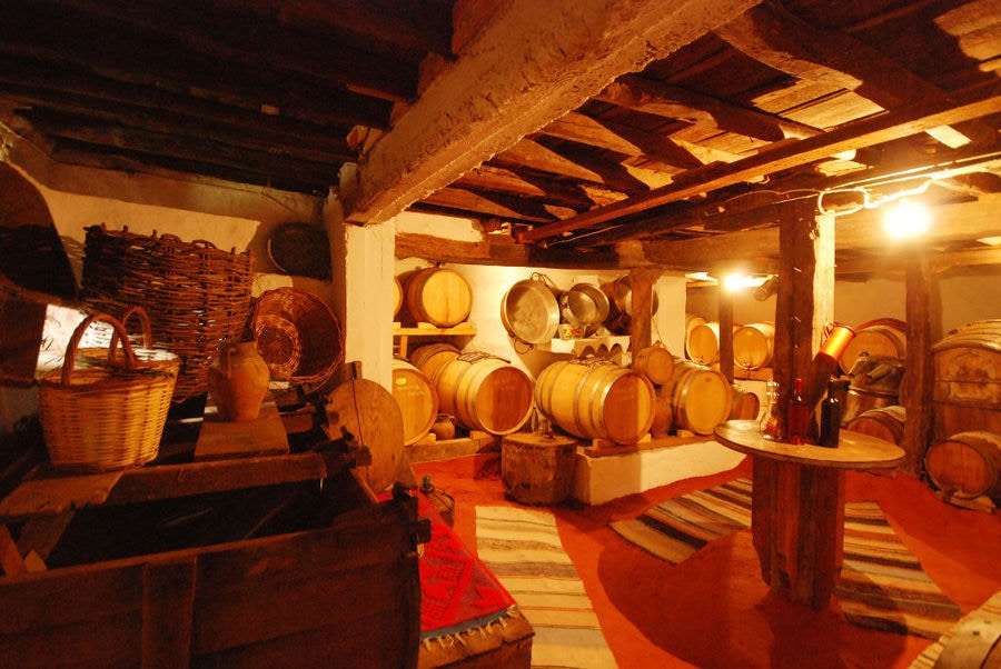 exhibition folklore room with wood ceiling at 'Dio Fili' with old wine barrels and traditional carpets
